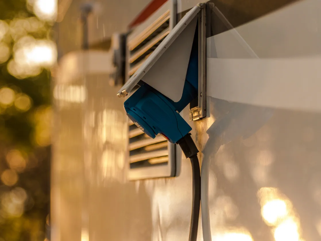 Marcus Reyes performing an electrical inspection on a Class A motorhome in Coral Gables
